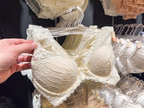 Woman Choosing White Underwear Lace Bra In Lingerie Store Stock Image