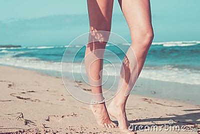 Tanned Legs Of A Woman Against The Sea Tropical Beach Scene Bali