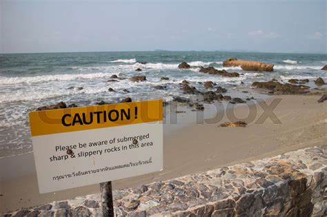 Warning Sign Of Submerged Sharp And Slippery Rocks Stock Image Colourbox