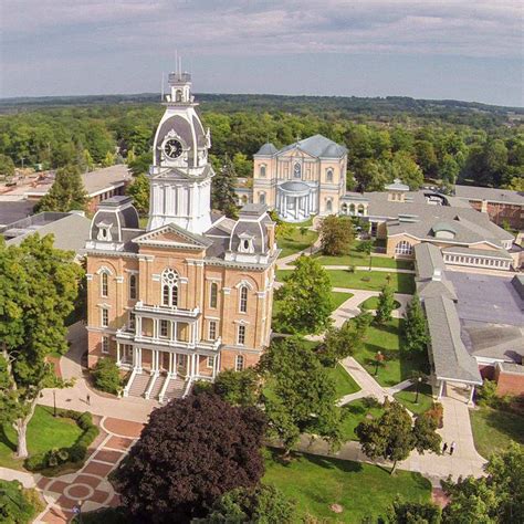 an aerial view of a large building surrounded by trees