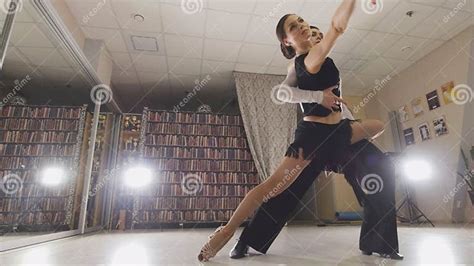 Young Attractive Man And Woman Dancing Latin American Dance In Costumes