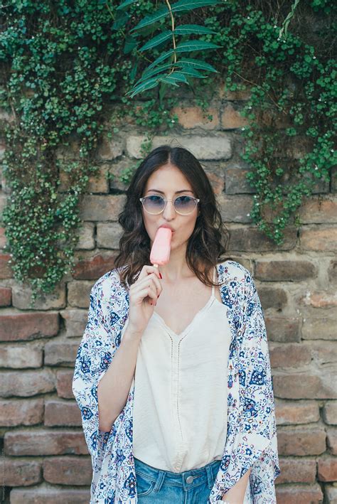 Brunette Girl Eating Pink Ice Cream By Stocksy Contributor Nemanja