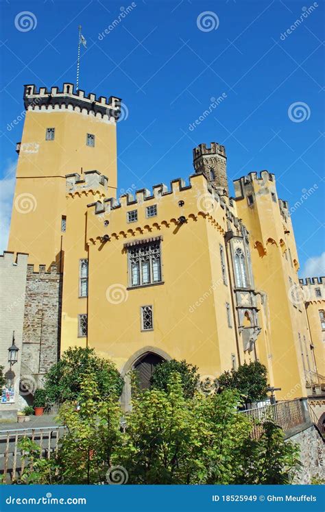 Yellow Castle With A Tall Tower That Is Reflected In The Moat Royalty ...