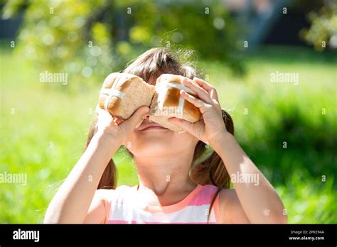 Girl Holding Easter Hot Cross Bun Stock Photo Alamy