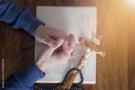 praying hands with bible Stock Photo | Adobe Stock