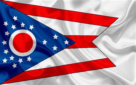 the flag of the state of ohio is waving in the wind, with red white and ...