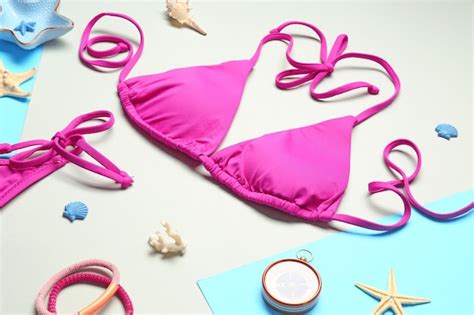 Premium Photo Bright Bikini And Seashells On Color Background