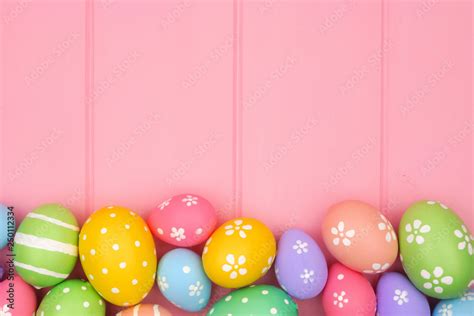 Colorful pastel Easter Egg bottom border against a pink wood background ...