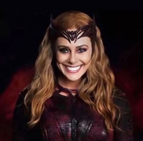 A Woman Wearing A Mask With Long Hair And Horns On Her Head Smiling At