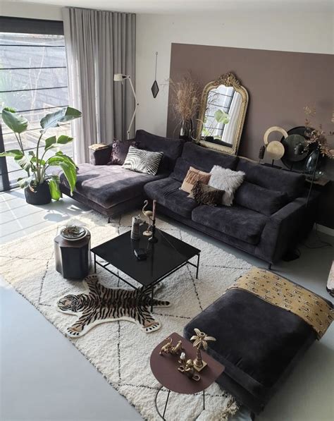 black, velvet sofa surrounded with beautiful fabrics and warm colors