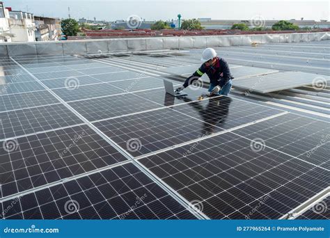 A Technicians Is Using An Electric Meter And A Laptop To Check The