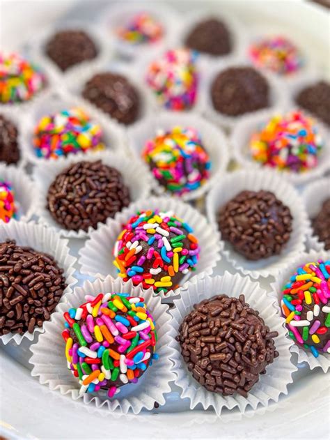 There Are Many Chocolates With Sprinkles On The Plate