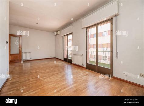 Empty Living Room Of A Residential House With Oak Parquet Flooring