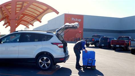 BEMIDJI, MN - 30 APR 2020: Walmart Employee Puts Bags into Car for ...