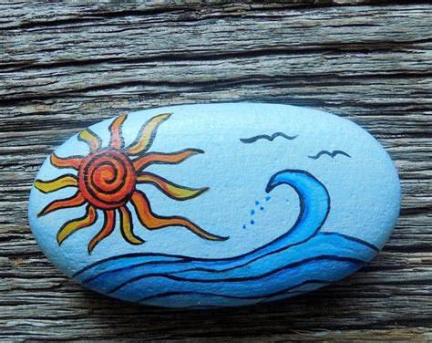 A Painted Rock Sitting On Top Of A Wooden Table