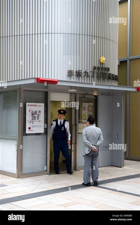 Pedestrian Stops By A Koban Police Box To Ask A Question Police