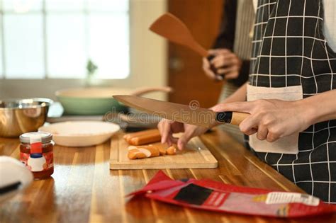 Close Up Of A Gay Couple Cooking Together In A Cozy Kitchen Stock Image Image Of Embracing