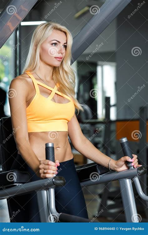 Athletic Blonde Woman Using Press Machine In Gym Stock Photo Image Of