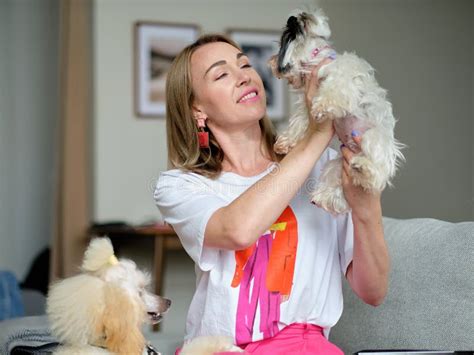 A Woman Lovingly Looks at a Beaver Yorkshire Terrier Dog Holding it in ...