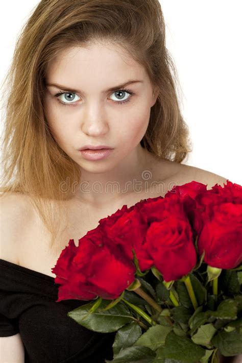 Portrait Of A Young Beautiful Girl With A Bouquet Of Red Roses Stock