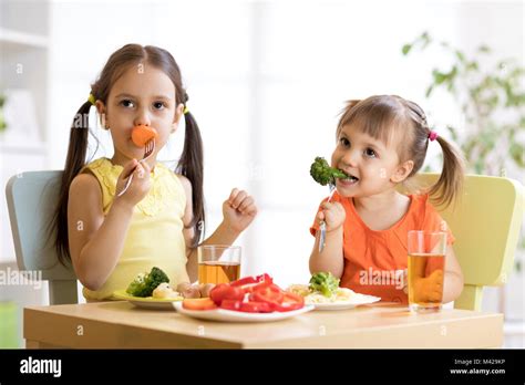 kids children eating vegetables in kindergarten or at home Stock Photo ...