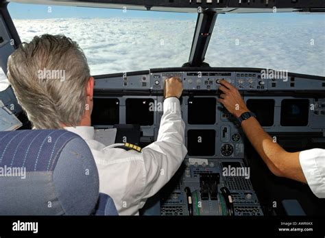 Pilots in the cockpit of an Airbus 321, in flight Stock Photo - Alamy