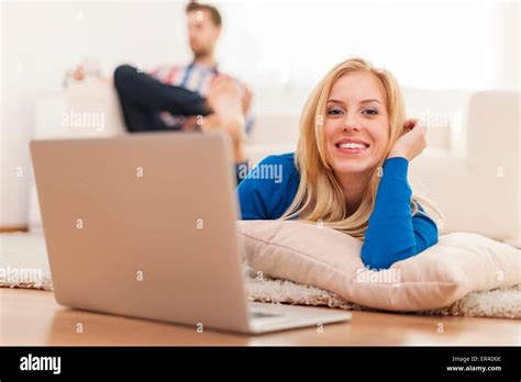 Beautiful Blonde Woman Lying Down On Carpet At Home And Using Laptop Stock Photo Alamy