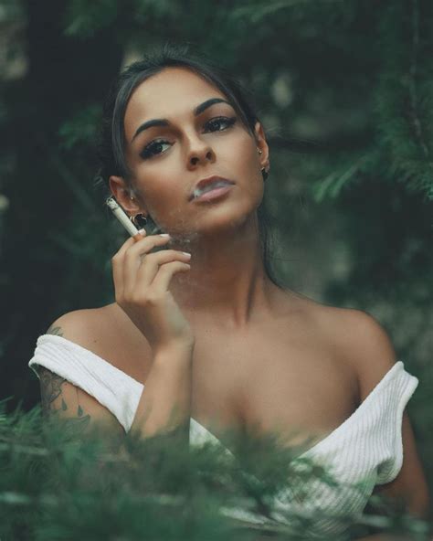 A Woman In White Dress Holding A Cell Phone To Her Ear And Looking Off