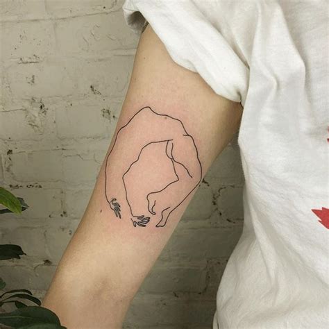 A Woman S Arm With A Bear Tattoo On The Left Side Of Her Arm