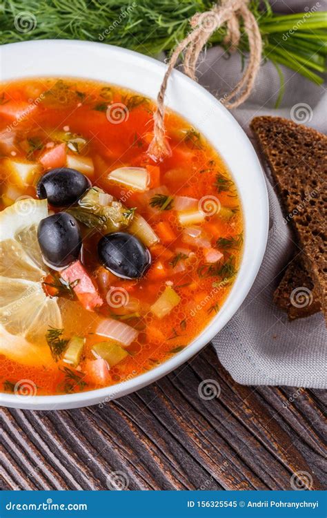 Traditional Russian Meat Soup Solyanka In Bowl On Rustic Wooden Table