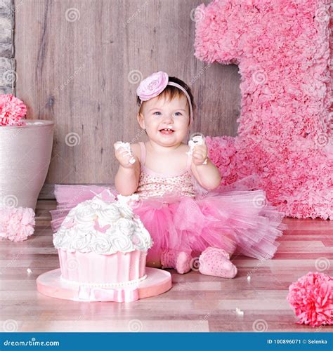 1 Year Baby Girl In Pink Dress With Her First Birthday Cake Stock Image