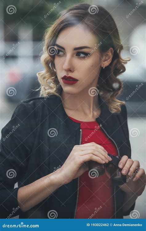 Beautiful Brunette Sexy Spy Agent Killer Or Police Woman In Leather Jacket And Red Luxury Dress