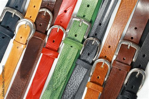 Colored Leather Belts On White Background Photographed Vertically Stock