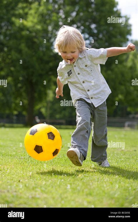 Little boy kicking a with a ball Stock Photo - Alamy