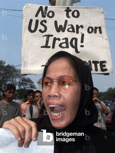 Image Of A FILIPINO MUSLIM WOMAN SHOUTS ANTI US SLOGANS DURING MARCH IN