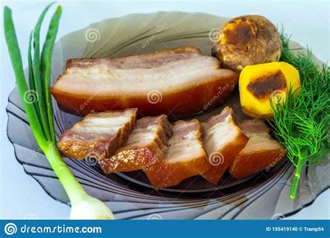 Smoked Appetizing Pork Belly With Vegetables On A Plate Stock Photo