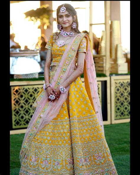 Yellow Cutwork Lehenga With Green Choli And Pink Bandhni Dupatta