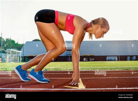 Young Woman Athlete At Starting Position Ready To Start A Race On