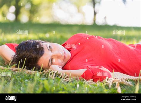 Mature Woman Lying On Grass Stock Photo Alamy