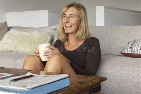 Attractive Blonde Woman In Dark Dress Falls Down The Stairs She Is Holding A Large Knife To
