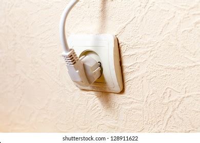 european  volt power outlet halfplugged stock photo