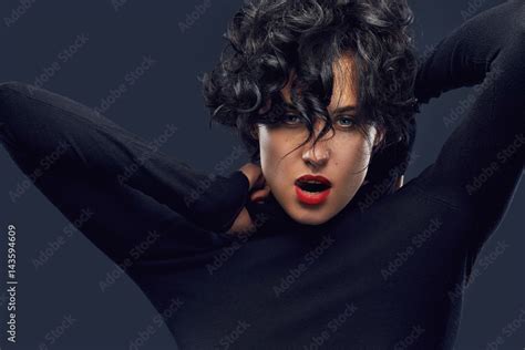 Brunette Woman With Curly Hair Expressive Blue Eyes And Red Lips On Dark Background Stylish