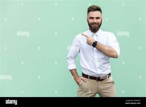 Portrait Of Satisfied Delighted Bearded Businessman Wearing White Shirt