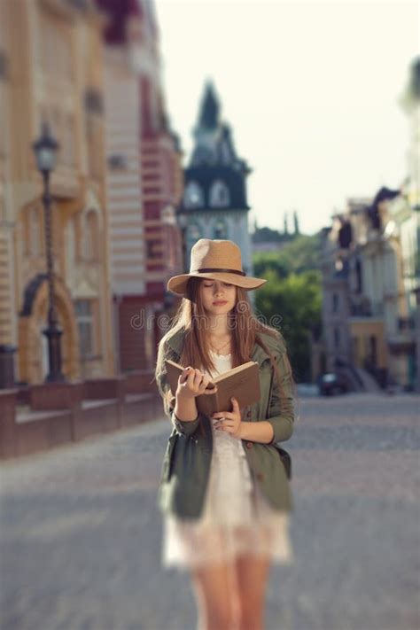 Girl reading book outdoors stock image. Image of outdoor - 56304157