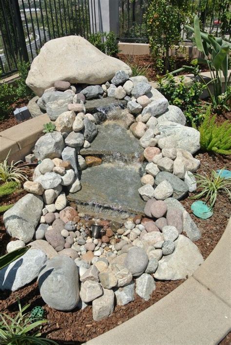 Natural boulder water feature | Hardscape, Landscape design, Concrete yard