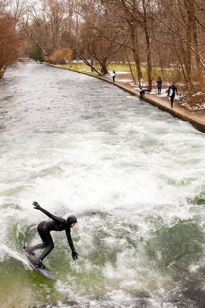 Premium Photo | Woman is surfing in munich's central park the english ...