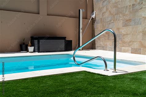 Swimming Pool With Artificial Grass A Handrail With Stairs A Shower