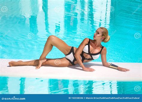 Elegant Woman In Luxury Bikini On The Sun Tanned Slim And Shapely Body