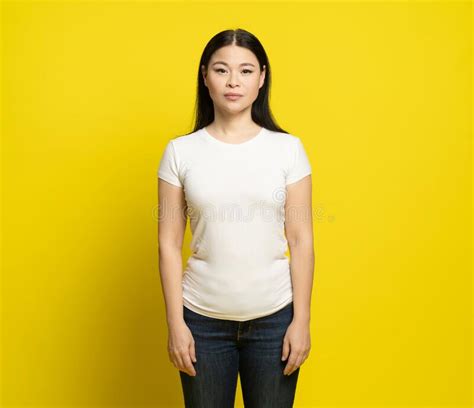 Sad Asian Woman With Long Hair Wearing White T Shirt And Jeans Standing