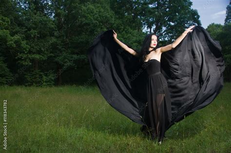 Beautiful Brunette Woman In Black Dress And Black Cloak In The M Stock Photo Adobe Stock